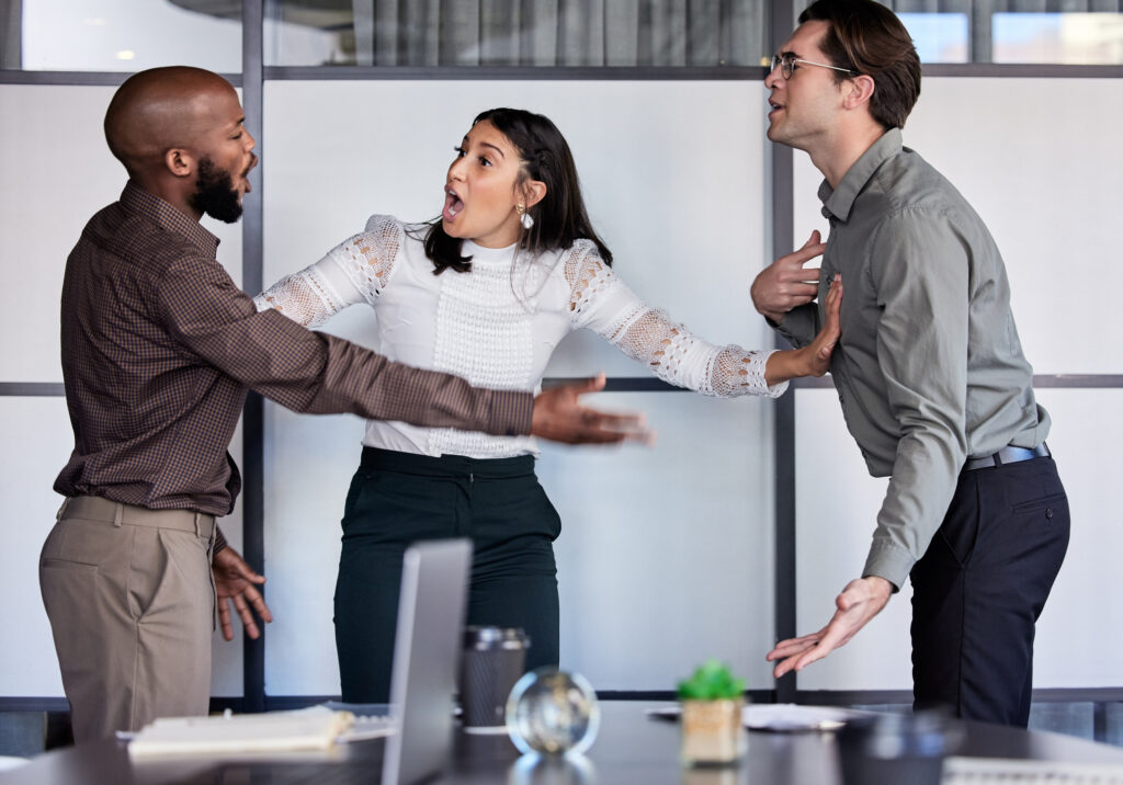 Co-workers arguing with a person trying to intervene